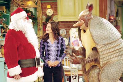 Courteney Cox as Monica and David Schwimmer as Ross, wearing the “Holiday Armadillo” costume, star in “Friends.” ©2009 Warner Bros. Entertainment, Inc.